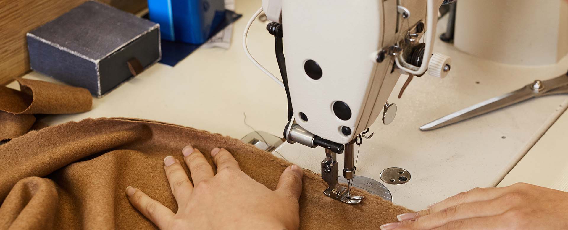 Tailor sewing on machine